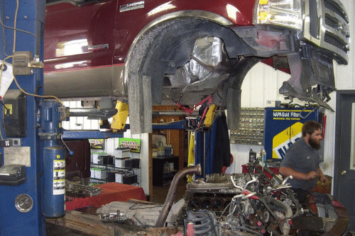 A Mevert Automotive technician goes to grab a tool for a Powerstroke diesel engine repair.