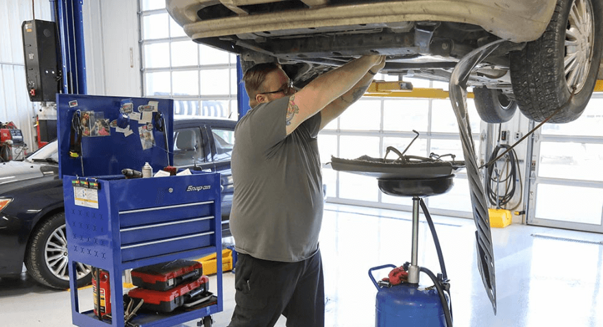 A technician doing auto repair work at Mevert Automotive