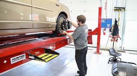 A mevert automotive mechanic replacing tires