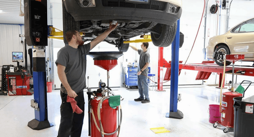 Two technicians working under a vehicle at Mevert Automitive. We provide a wide range of services and repairs