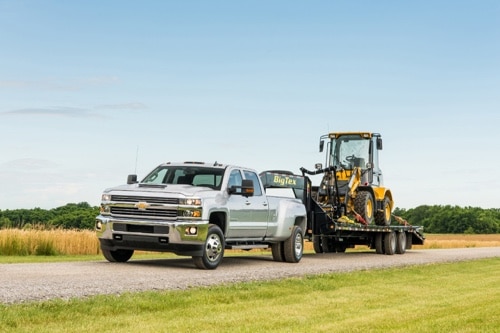 Maintenance for Your Duramax Diesel in Steeleville, IL with Mevert Automotive & Tire Center; image of Chevrolet Duramax Diesel pickup truck pulling heavy equipment vehicle on a trailer