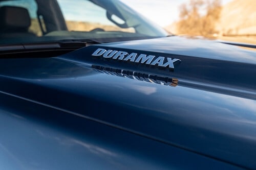 Diesel Engines Compared | Mevert Automotive & Tire Center in Steeleville, IL. Closeup image of a “Duramax” sign on a blue 2020 Chevrolet Silverado Diesel.