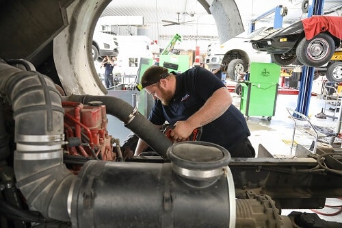 Heavy-Duty Diesel Repair in Steeleville, IL | Mevert Auto. Image of Mevert’s mechanic working on an engine of a heavy-diesel truck in an auto repair shop.