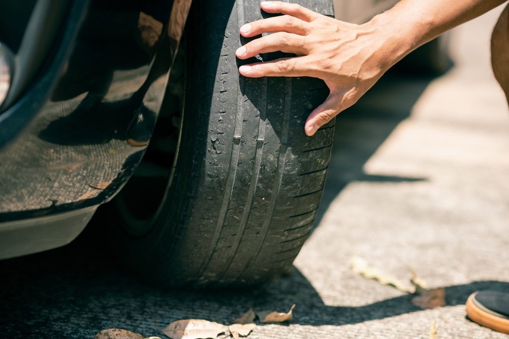 Understanding Tire Wear | Mevert Automotive and Tire Center Tips. Image of worn tires on car.