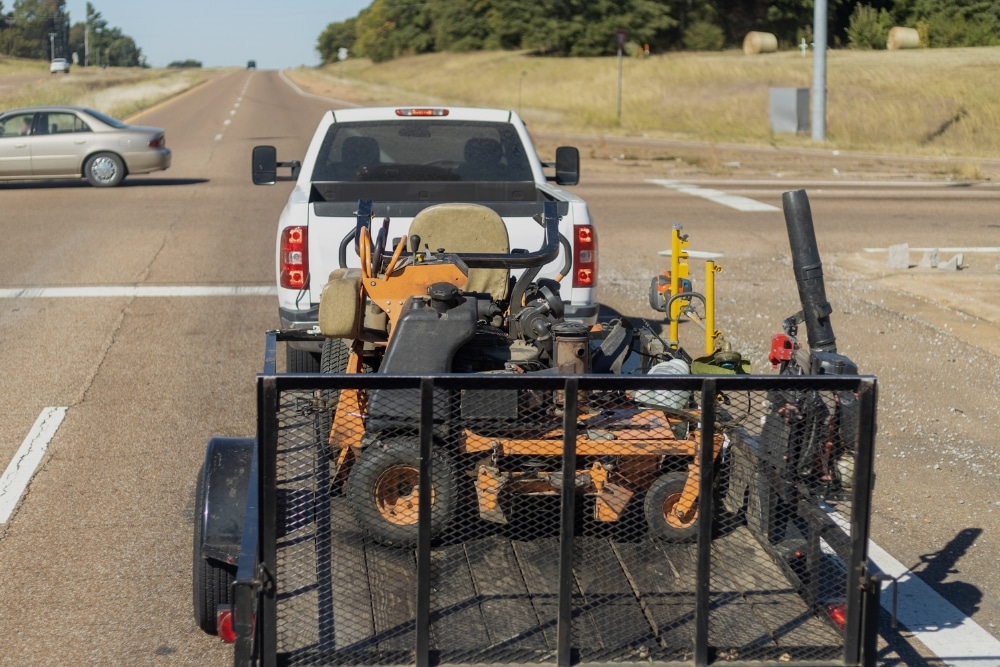 Diesel truck towing lawn equipment on trailer near Steeleville IL highway intersection. Diesel Truck Repair In Steeleville IL At Mevert Automotive
