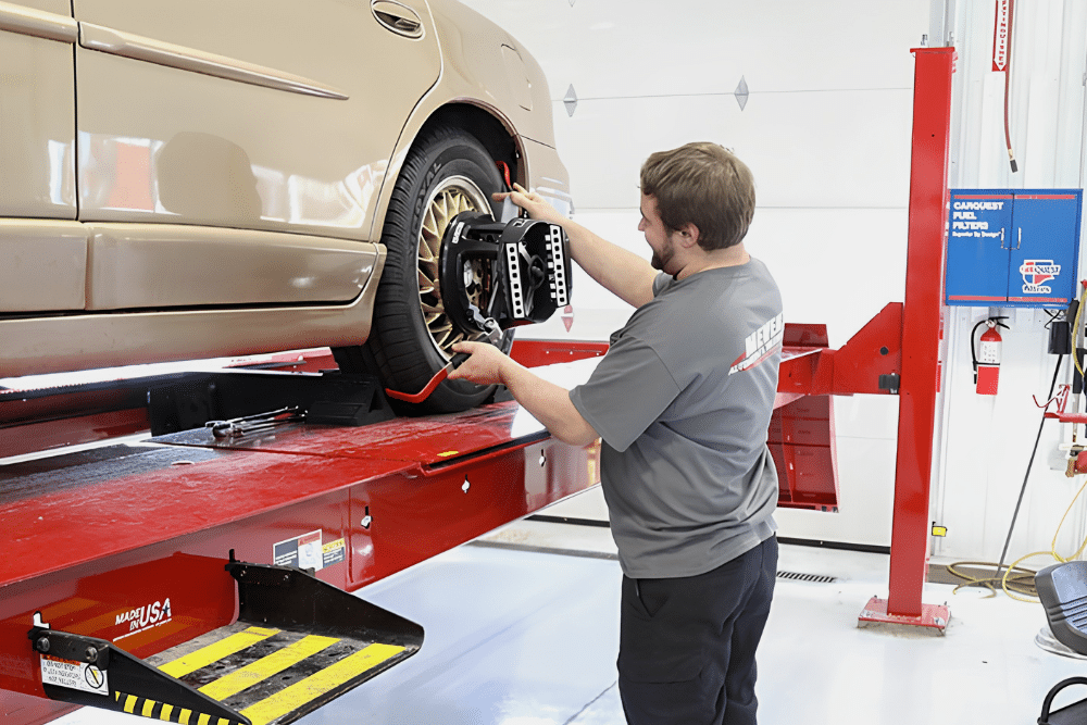Tire Balancing vs. Wheel Alignment, Wheel Alignment Service in Steeleville IL At Mevert Automotive. Image of Technician mounting a wheel alignment sensor clamp