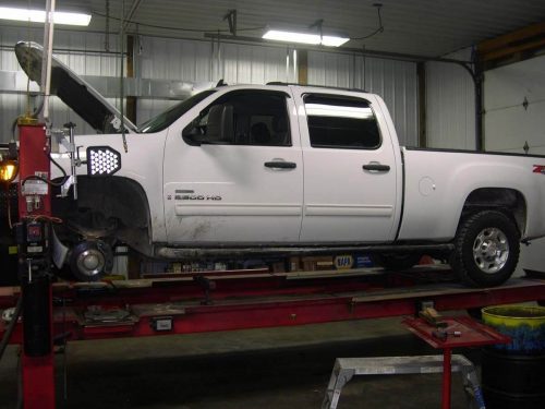 A truck with a Duramax diesel engine sits on a lift at Mevert Automotive